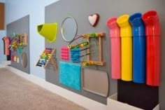 there are many toys on the wall in this children's playroom, and it is colorful