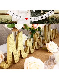 a table topped with flowers and wooden letters