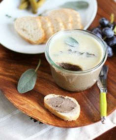 a plate with bread and grapes on it