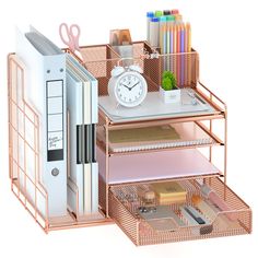 a pink desk organizer with drawers and a clock on the top, next to other office supplies