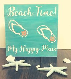 a sign that says beach time my happy place and two starfishs on the ground