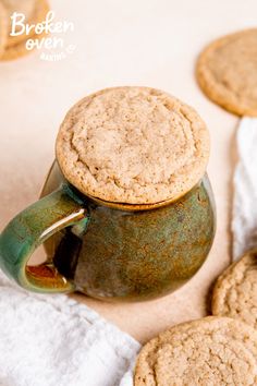 some cookies are next to a tea pot