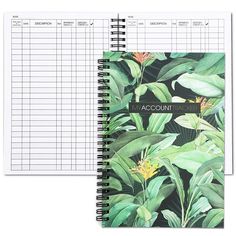 a notebook with an image of tropical leaves and flowers on it