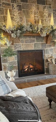 a living room filled with furniture and a fire place in front of a stone fireplace