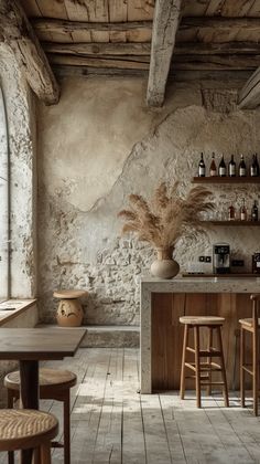 an old - fashioned bar with wooden stools and stone walls