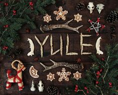 a wooden table topped with christmas decorations and cookies