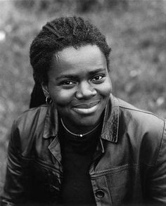 a black and white photo of a woman smiling