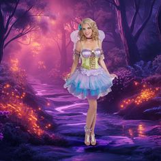 a woman in a fairy costume standing on a path