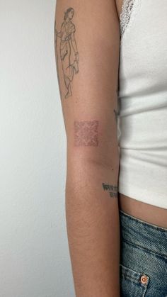 a woman with a tattoo on her arm