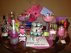 a table topped with lots of different types of gifts and bottles on top of it