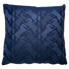 a blue pillow with an abstract design on the front and back, sitting on a white background