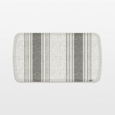 a gray and white striped bath mat on a white background with an empty space for text