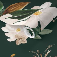 the wallpaper has white flowers and green leaves on it, along with an empty roll of paper