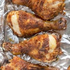 baked chicken wings on tin foil with seasoning in the middle, ready to be cooked