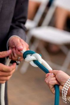 two people are pulling a rope with their hands