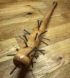 a wooden toy with spikes on it laying on the floor