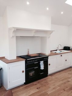 a kitchen with an oven, stove and counter tops in the middle of the room