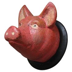 a red pig head mounted on a black hook