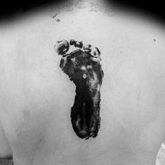 a black and white photo of a foot print on the back of a person's body