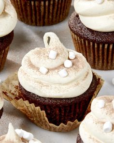 cupcakes with white frosting and marshmallows on top