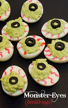 Eggs with green filling, olive eyes and red veins with text Avocado Deviled Eggs, Monster Eyes