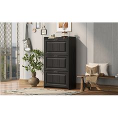 a black cabinet sitting on top of a wooden floor