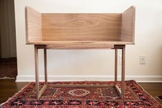 a wooden bench sitting on top of a rug