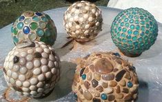 four decorative balls sitting on top of a table