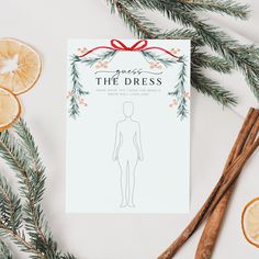 an orange slice and cinnamon sticks next to a paper with the words guess the dress on it