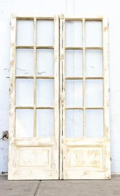 an old white double door with glass panes