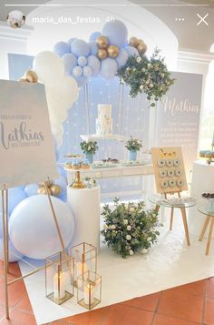 a white table topped with lots of balloons and desserts next to a cake stand