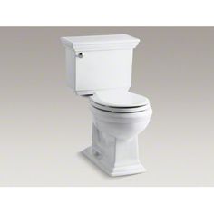 a white toilet sitting on top of a gray floor