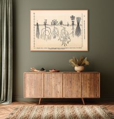 a painting hanging on the wall next to a wooden cabinet with plants and flowers in it