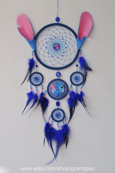 a blue and pink dream catcher hanging on the wall