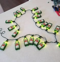 there are many bottles that have been lit up on the table for christmas lights to be strung across