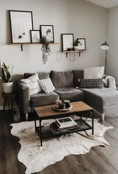 a living room filled with furniture and pictures on the wall