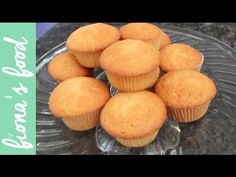 a glass plate topped with muffins on top of a counter