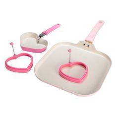 a white and pink tray with a heart shaped object on it's side next to a pair of scissors