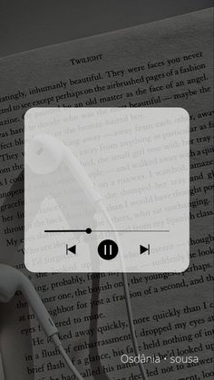 headphones are plugged into the earbuds in front of an open book