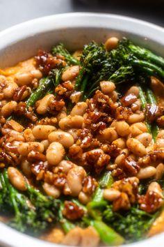 a white bowl filled with broccoli and beans