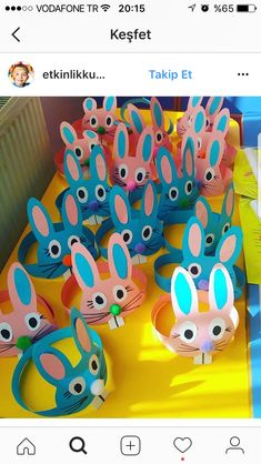 a table topped with lots of paper rabbits