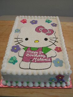 a hello kitty birthday cake on a table