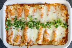 a casserole dish with meat and cheese covered in green onions on the side