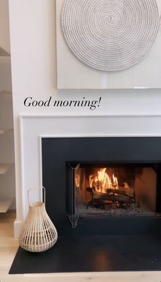 a white fireplace with the words good morning on it and a basket next to it