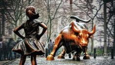 a statue of a woman standing next to a bull on a street with trees in the background