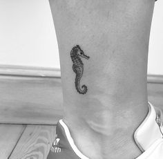 a small seahorse tattoo on the ankle