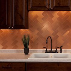 a kitchen with wooden cabinets and a white sink under a faucet next to a window