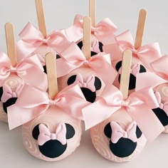 there are many minnie mouse cupcakes with toothpicks in the shape of them