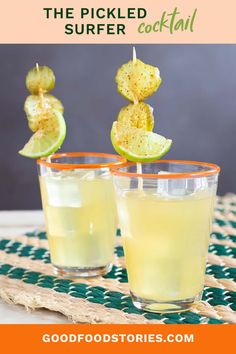 two glasses filled with drinks sitting on top of a table