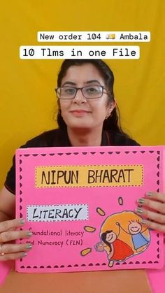 a woman holding up a pink sign that says nippun bhatt library